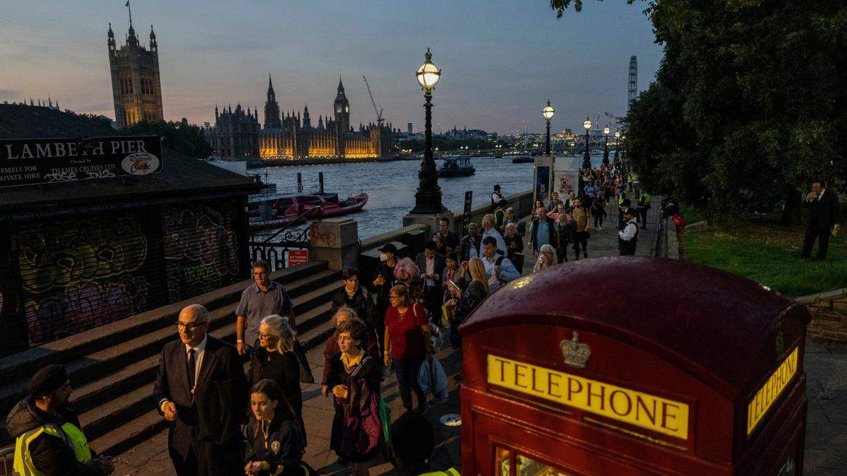 People queue to pay their respects to late Queen Elizabeth II who’s lying in state at Westminster Hall in London, Wednesday, Sept. 14, 2022.