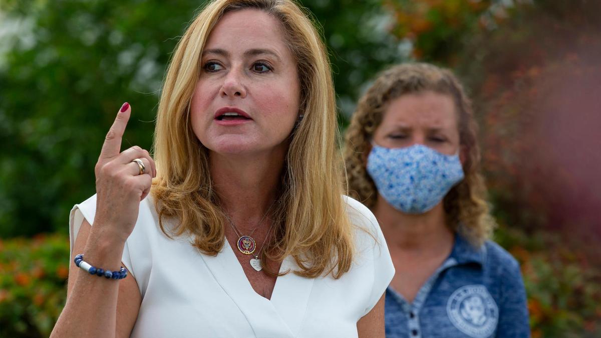 Democratic U.S. Reps. Debbie Mucarsel-Powell, left, and Debbie Wasserman Schultz speak during a press conference near the United States Postal Service mail distribution facility in Opa-locka, Florida on Tuesday, August 18, 2020.