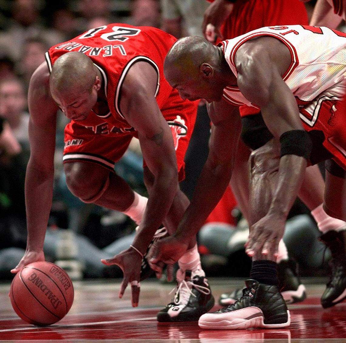 FILE PHOTO - Voshon Lenard and Michael Jordan chase after a loose ball during first quarter action. This was not the game where the undermanned Heat squad beat the Bulls.