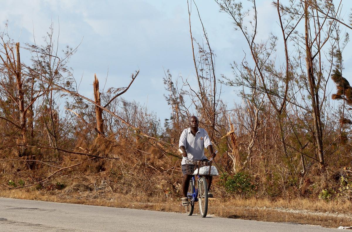 Josue Lifrandeu rides his bike along the S.C.Bootle Highway on Treasure Cay in Abaco, nine days after Hurricane Dorian devastated the Bahamas.