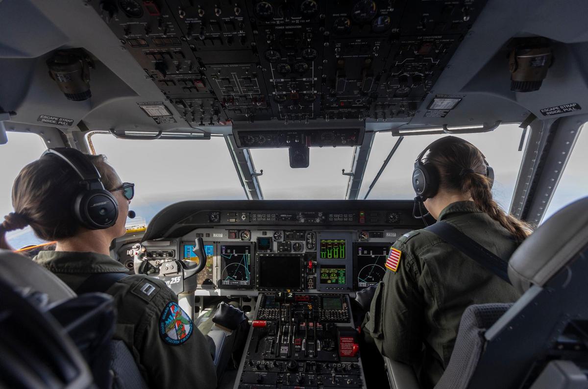 Miami, April 22 2022 - Lieutenant Katrina E. Prout, left, and Lt. j.g. Hannah Boyce, right, in the cockpit of a US Coast Guard HC-144 Ocean Sentry on a reconnaissance flight over the Florida straights and the Bahamas.