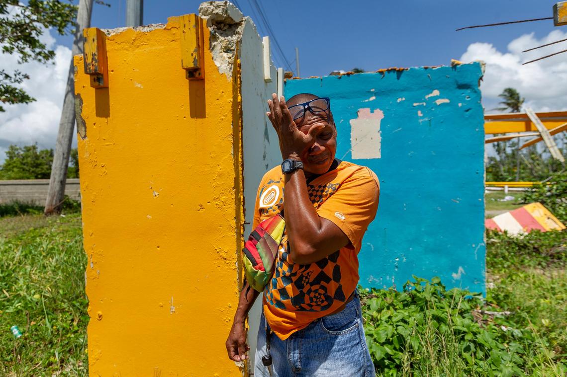 Jose Luis Aponte Cruz, 52, wipes a tear as he walked through the ruins of his beachside food kiosk “El Amarillo” in the Punta Santiago community of Humacao, Puerto Rico on August 23, 2018. Aponte Cruz lost his business last year in Hurricane Maria.