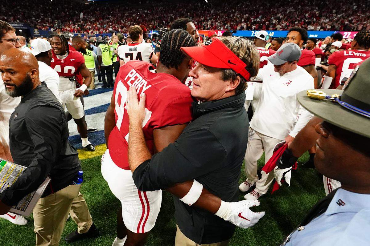 Dec 2, 2023; Atlanta, GA, USA; Georgia Bulldogs head coach Kirby Smart embraces Alabama Crimson Tide defensive lineman Khurtiss Perry (97) after the Alabama Crimson Tide defeated the Georgia Bulldogs in the SEC Championship at Mercedes-Benz Stadium. Mandatory Credit: John David Mercer-USA TODAY Sports