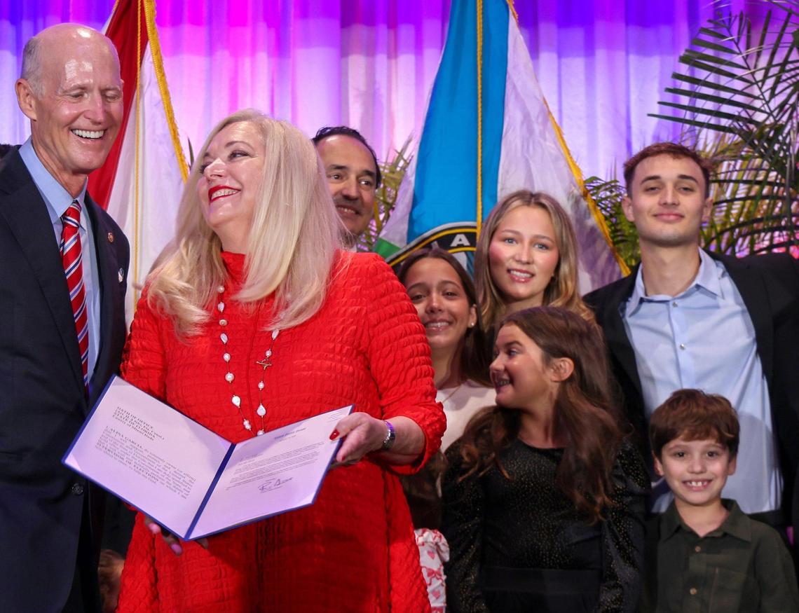 U.S. Sen. Rick Scott, left, smiles with Alina Garcia, center, after she took the oath of office as Miami-Dade’s elected supervisor of elections at the Milander Auditorium in Hialeah, Florida, on Monday, Jan. 13, 2025.