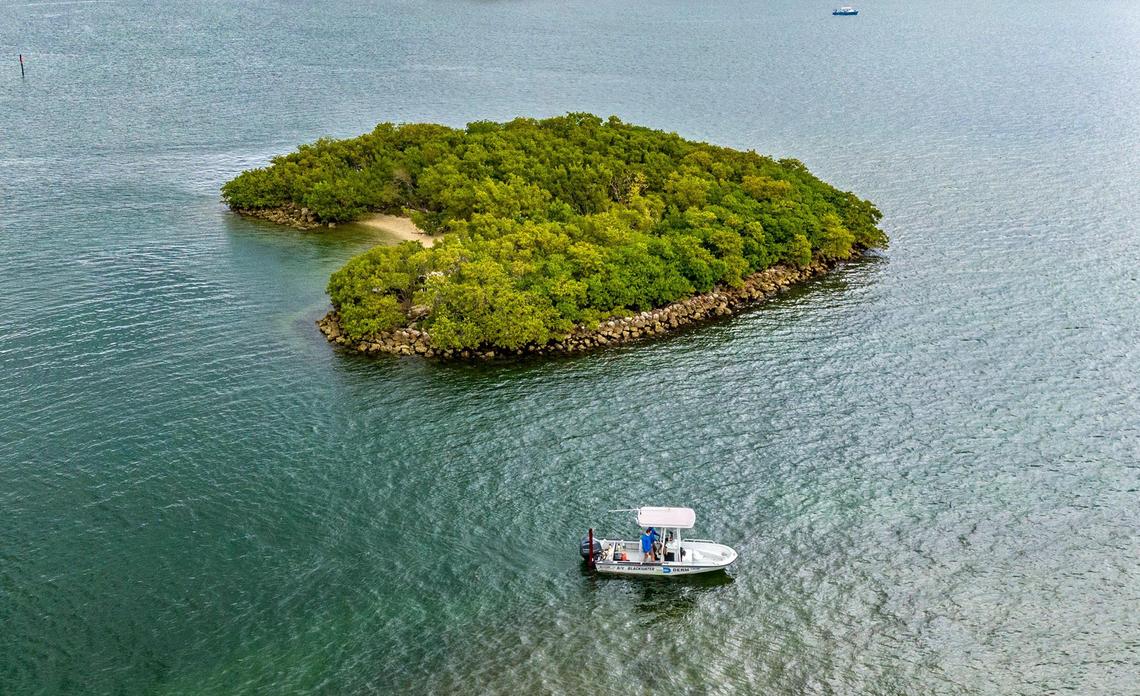 Scientists with the Department of Environmental Resources Management (DERM) navigate by the Crescent Island B, part of the county’s former living shorelines projects on Biscayne Bay.