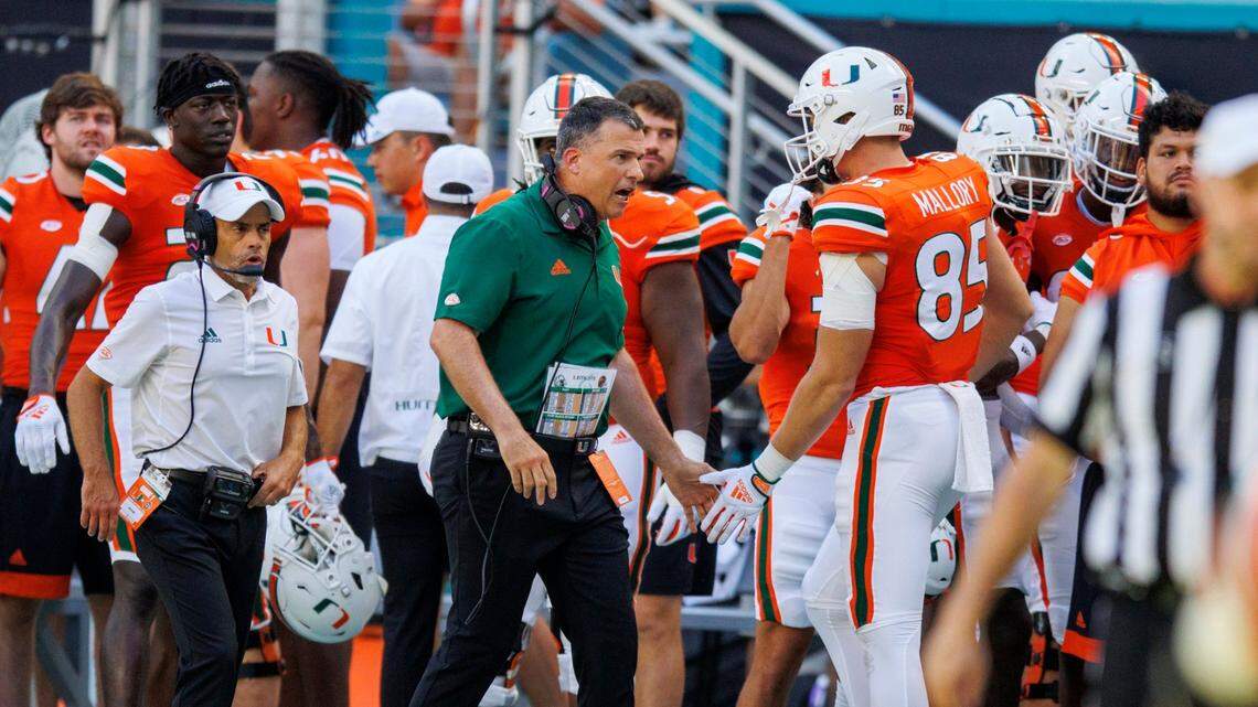 Miami Hurricanes tight end Will Mallory (85) is congratulated by head coach Mario Cristobal during the first quarter of a NCAA non conference football game against Bethune-Cookman Wildcats at Hard Rock Stadium on Saturday, September 3, 2022 in Miami Gardens, Florida.