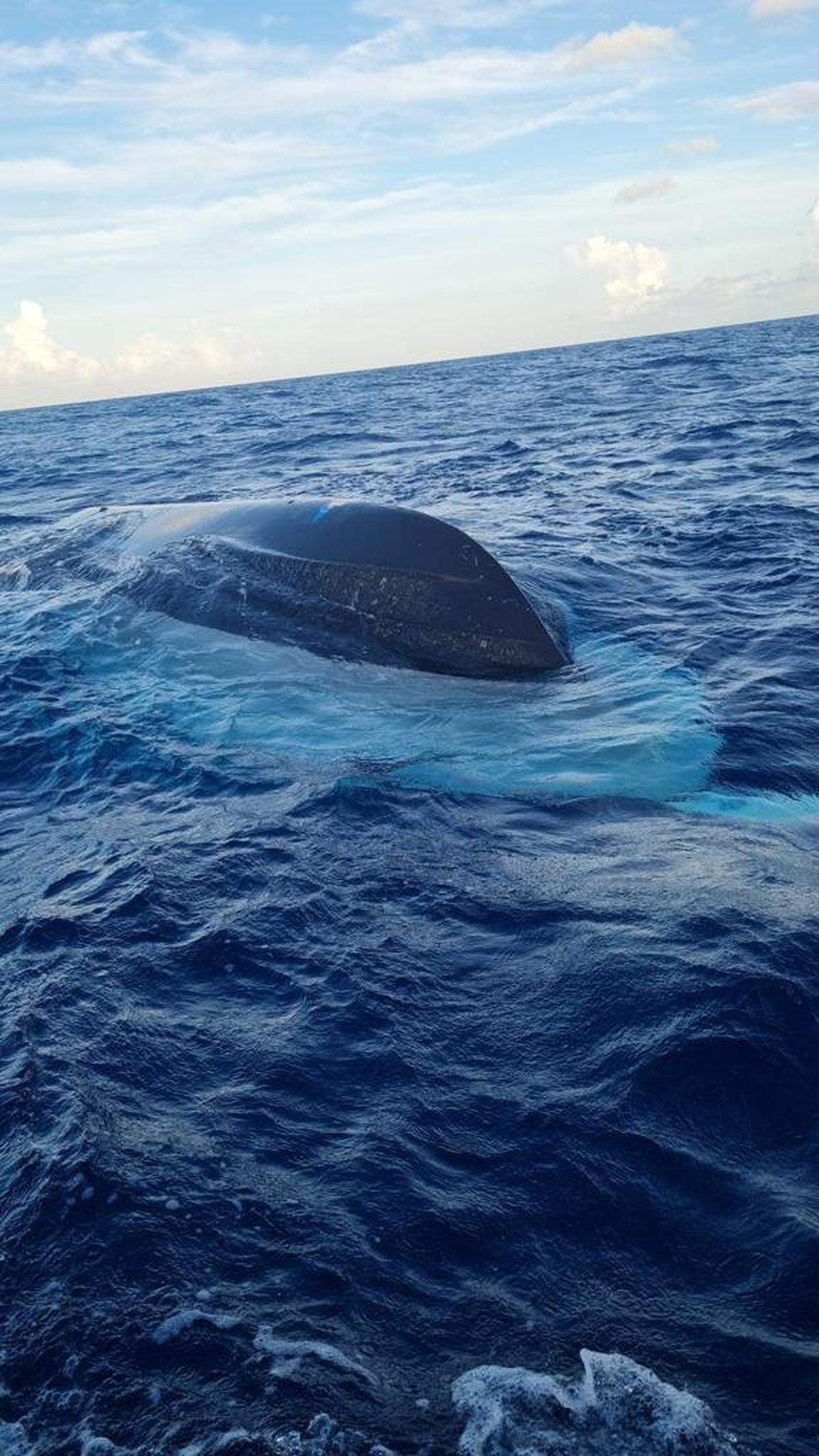 The half-sunk vessel that capsized in Bahamian waters, resulting in the death of at least 17 people suspected to be Haitian migrants on July 24, 2022.