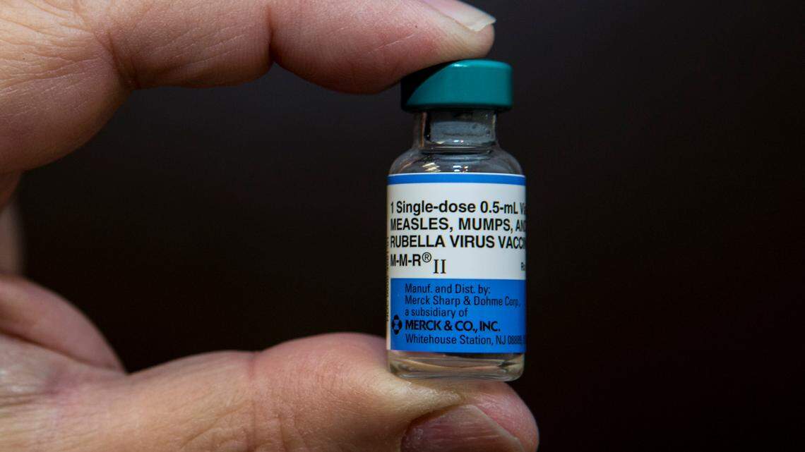 In this Thursday, Jan. 29, 2015 photo, pediatrician Charles Goodman holds a dose of the measles-mumps-rubella, or MMR, vaccine at his practice in Northridge, Calif. The vaccine is 99 percent effective at preventing measles, which spreads easily through the air and in enclosed spaces.