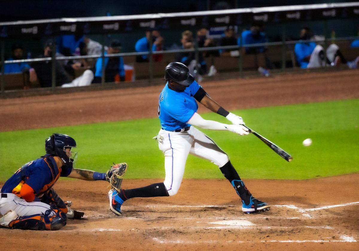 Miami Marlins center fielder Lewis Brinson (25) bats against the Houston Astros during the ninth inning of the spring training baseball game at Roger Dean Chevrolet Stadium on Wednesday, March 10, 2021 in Jupiter, Florida.