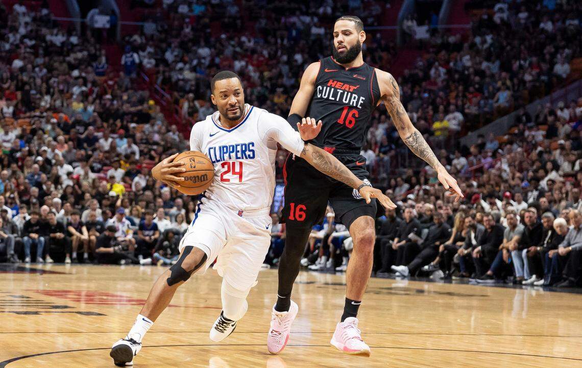 Miami Heat forward Caleb Martin (16) defends as Los Angeles Clippers guard Norman Powell (24) drives the ball in the first quarter of an NBA game at the Kaseya Center on Sunday, Feb. 4, 2024, in Miami, Fla.