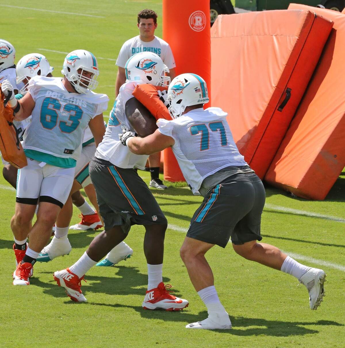 Miami Dolphins center Mike Matthews (63), Dolphins tackle Roubbens Joseph (73) and Dolphins tackle/guard Jesse Davis (77) run drills during the Miami Dolphins Organized Team Activities at the Baptist Health Training Facility at Nova Southeastern University on Wednesday, June 6, 2018 in Davie.