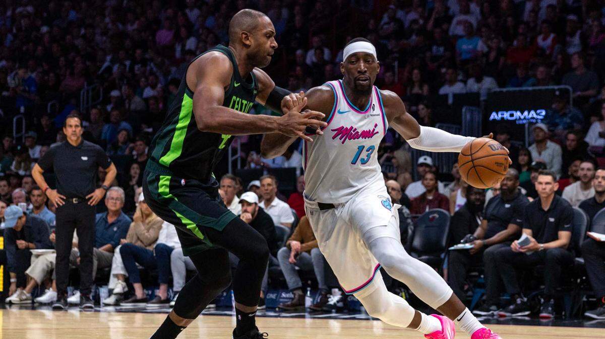 Miami Heat center Bam Adebayo (13) dribbles while defended by Boston Celtics center Al Horford (42) during the second half of an NBA game at Kaseya Center on February 10, 2025, in Miami.