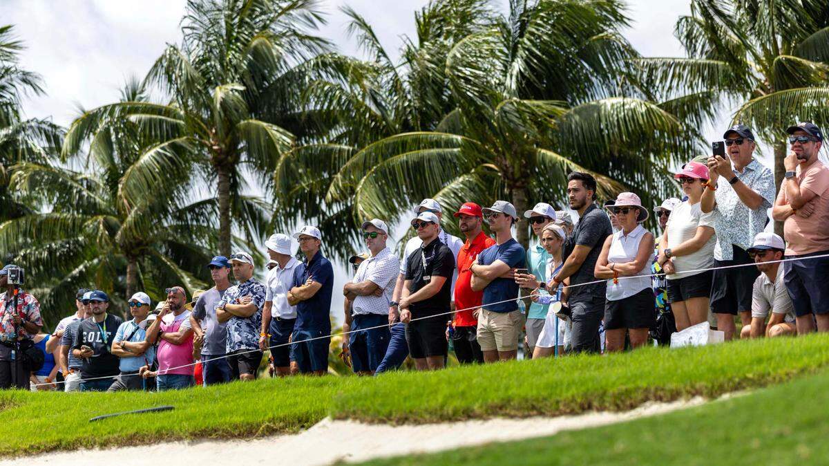 Golf fans react to a putt from the gallery on the first green during Day 3 of the LIV Golf Miami at Trump National Doral on Sunday, April 6, 2025, in Doral, Fla.