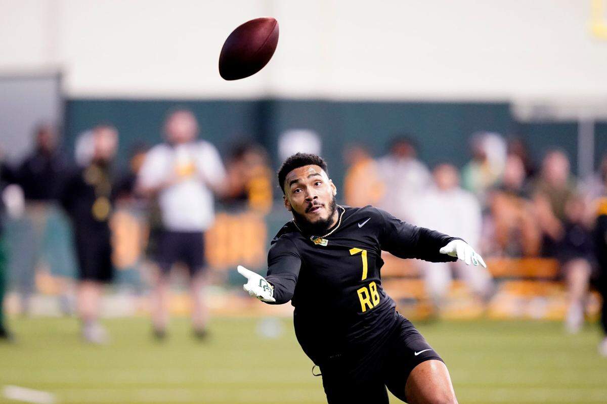Running back Abram Smith reaches for the ball during Baylor’s NFL Pro Day in Waco, Texas, Wednesday, March 30, 2022. (AP Photo/LM Otero)