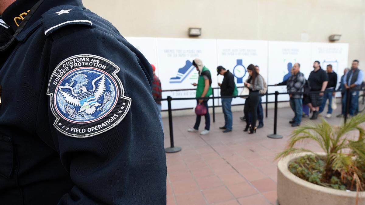 Pedestrians crossing from Mexico into the United States at the Otay Mesa Port of Entry wait in line in San Diego on Dec. 10, 2015.