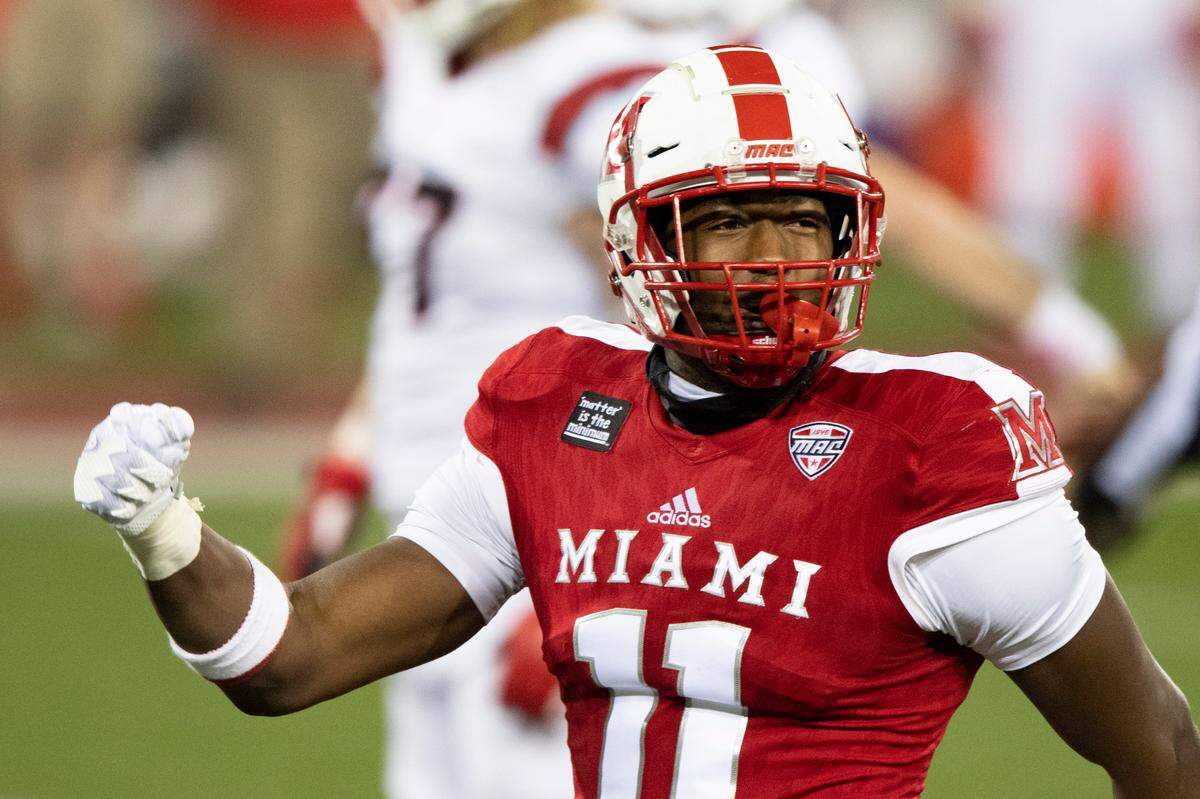 Miami (Oh) Redhawks defensive lineman Dominique Robinson (11) celebrates a sack during an NCAA football game against the Ball State Cardinals on Wednesday, Nov. 4, 2020 in Oxford, Ohio. (AP Photo/Emilee Chinn)