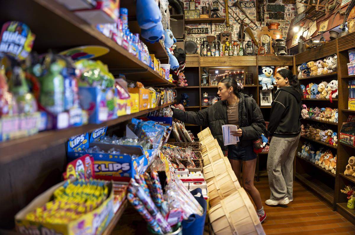 Angela Brizuela, center, and Aurora Araujo shop for candy at Jaxson's Ice Cream Parlor & Restaurant on Thursday, Feb. 5, 2026, in Dania Beach, Fla. Jaxson's is celebrating its 70th anniversary this month.