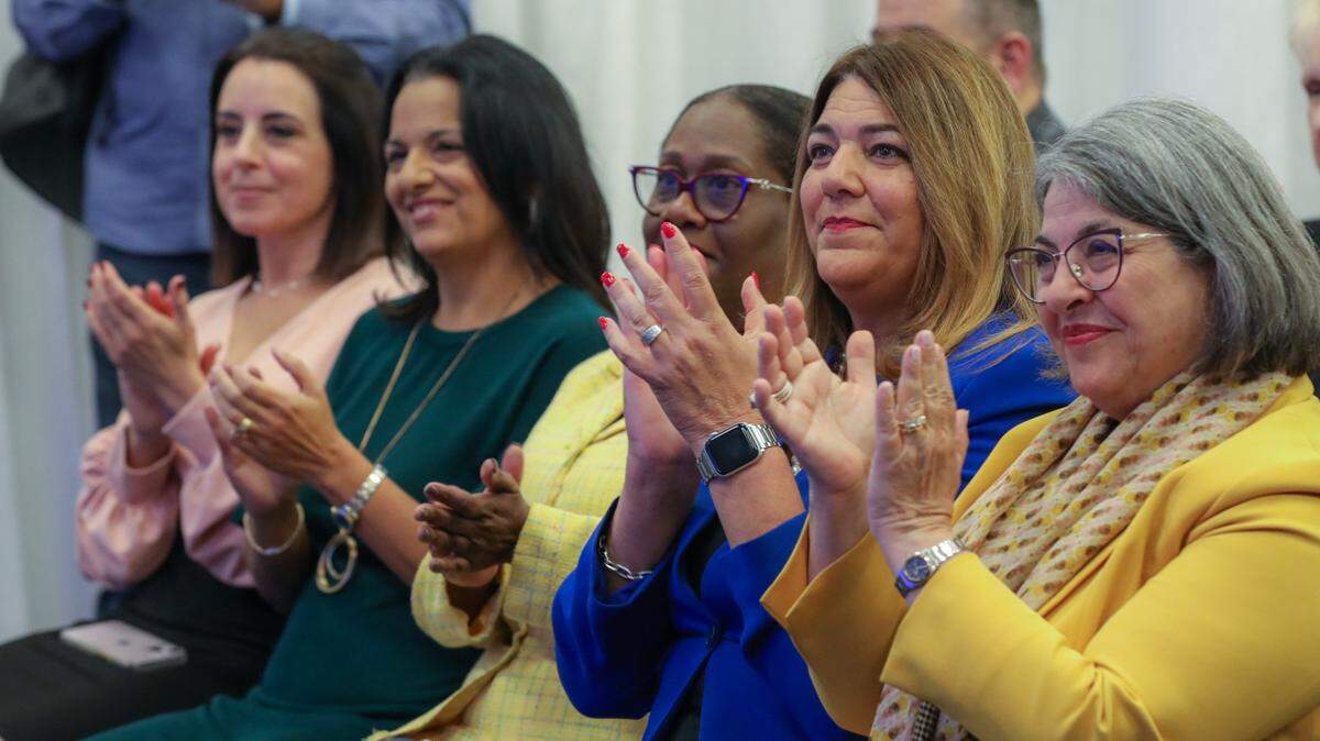 Miami-Dade County Mayor Daniella Levine Cava (far right) and Miami Dade College President Madeline Pumariega clap during a press conference about the first-of-its-kind “Future Ready Miami-Dade Scholarship Program” held at the college’s Wolfson Campus in Downtown Miami on October 30, 2023.