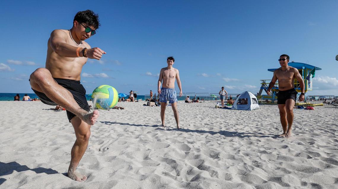 North Central College, Jose Mendoza, and Dillon Tierney, from Chicago, join Pierce Fequiere, of Connecticut, kicking a ball during spring break on Miami Beach, Florida on Friday, March 14, 2025.