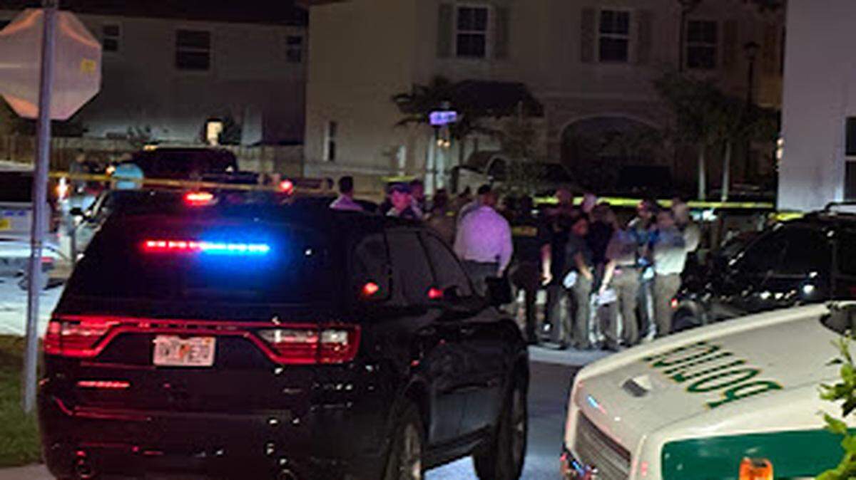 Miami-Dade deputies and detectives gather at Southeast 25th Avenue and 28th Drive in Homestead on Monday night. The sheriff’s office said one or more of its deputies opened fire on a person.