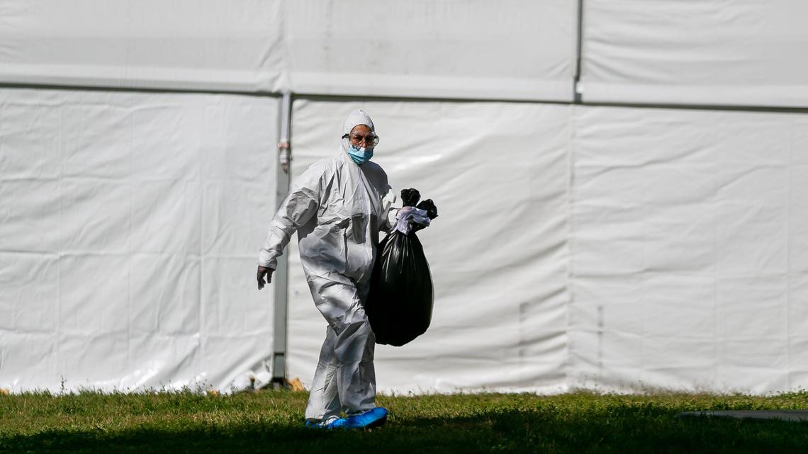 A worker outside a monoclonal antibody treatment site for COVID-19 at Markham Park in Sunrise, Florida, on Wednesday, Jan. 19, 2022.