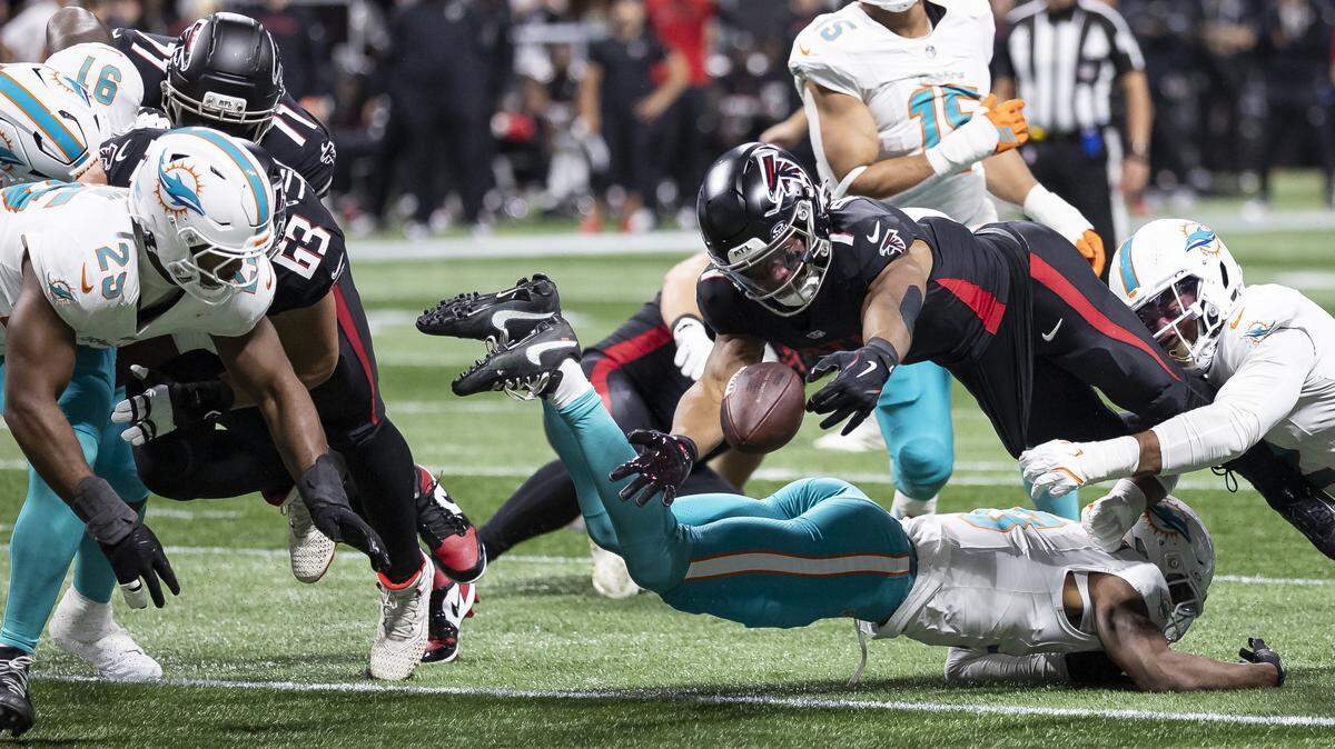 Miami Dolphins linebacker Bradley Chubb (2) forces Atlanta Falcons running back Bijan Robinson (7) to fumble the ball in the second half of their NFL game at Mercedes-Benz Stadium on Sunday, Oct. 26, 2025, in Atlanta, Ga.