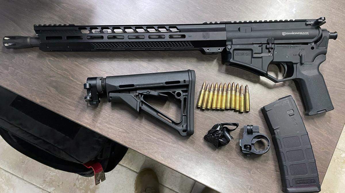 A semiautomatic rifle, a magazine, rifle stock and ammunition are displayed on a Monroe County Sheriff’s Office table following an arrest made Thursday, Oct. 26, 2023.