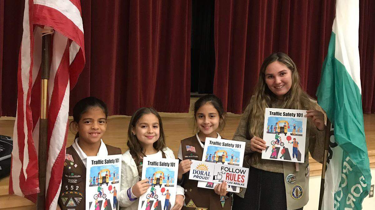Regina Gallardo of the School for Advanced Studies recently earned the Gold Award from the Girl Scouts for her traffic rules awareness program, which includes a series of comic books that teach students about the rules of the road. Regina, a member of Girl Scouts Troop 552, is pictured at the far right holding her comic book with younger Girl Scouts.