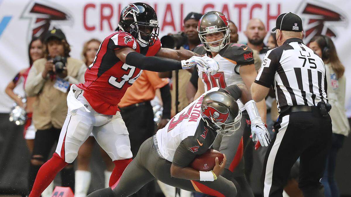 Atlanta Falcons cornerback Brian Poole, left, puts a hit on Tampa Bay Buccaneers quarterback Jameis Winston, knocking him out of bounds, during the second quarter of an NFL football game Sunday, Oct 14, 2018, in Atlanta.