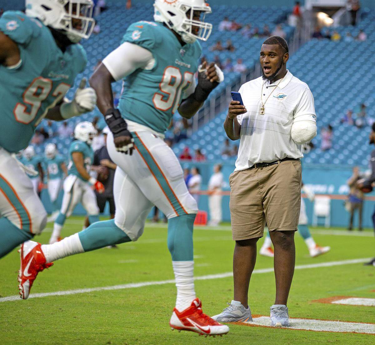 An injured Miami Dolphins defensive tackle, Kendrick Norton, watches the team practice before the Miami Dolphins host the Atlanta Falcons at Hard Rock Stadium in Miami Gardens on Thursday, August 8, 2019.
