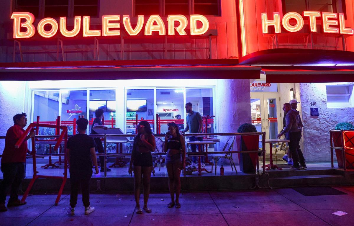 The Boulevard Hotel closes up at 8:30 p.m. during a spring break gathering of people on Ocean Drive on Sunday, March 19, 2023, in Miami Beach. A curfew was imposed in Miami Beach for 11:59 p.m. due to two deadly shootings the previous days.