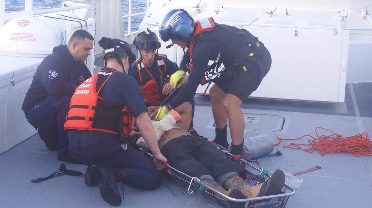 Coast Guard members prepare a patient to be hoisted after a boat collision on Oct. 15, 2019, about 35 miles northwest of Dry Tortugas. Two men were transferred to Lower Keys Medical by a Coast Guard Air Station Clearwater MH-60 Jayhawk helicopter crew and the Coast Guard Cutter Isaac Mayo crew after sustaining injuries from the collision.