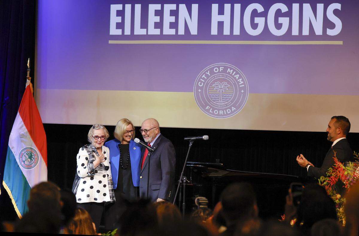 Cornelius and Patricia Higgins on stage with their daughter Eileen Higgins during the installation ceremony as the Mayor of the City of Miami at the Miami-Dade College Wolfson Campus Auditorium in Miami, Florida, on Thursday, December 18, 2025. 