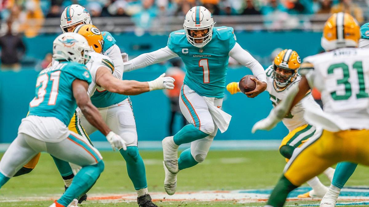 Miami Dolphins quarterback Tua Tagovailoa (1) leaps as he scrambles in the backfield as the Green Bay Packers defend in the first quarter at Hard Rock Stadium in Miami Gardens, Florida on Sunday, December 25, 2022.