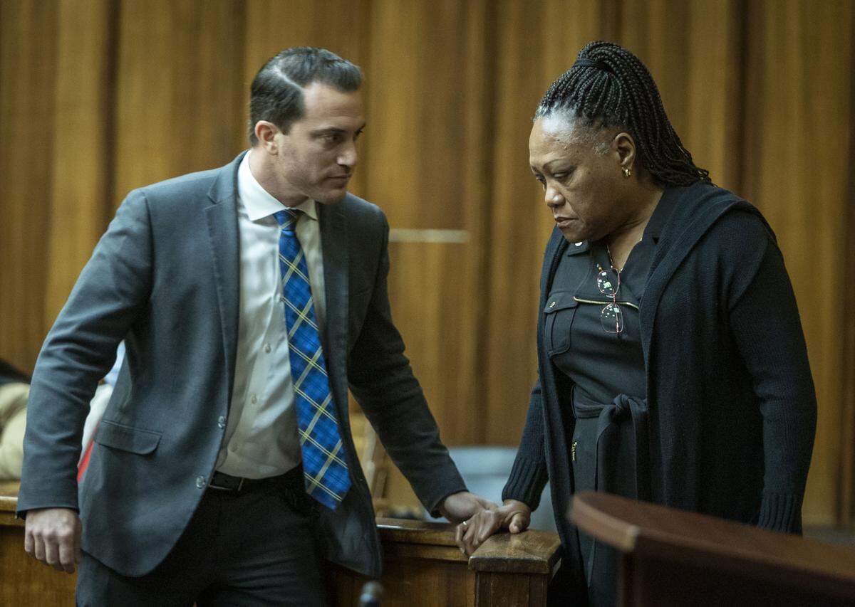 Miami, FL, October 28, 2025 - Charlie Postell, right, the mother of Marlin Barnes, confers with Miami-Dade assistant state attorney Shawn Abuhoff, left, before approaching the podium to read her impact statement to jurors. 
