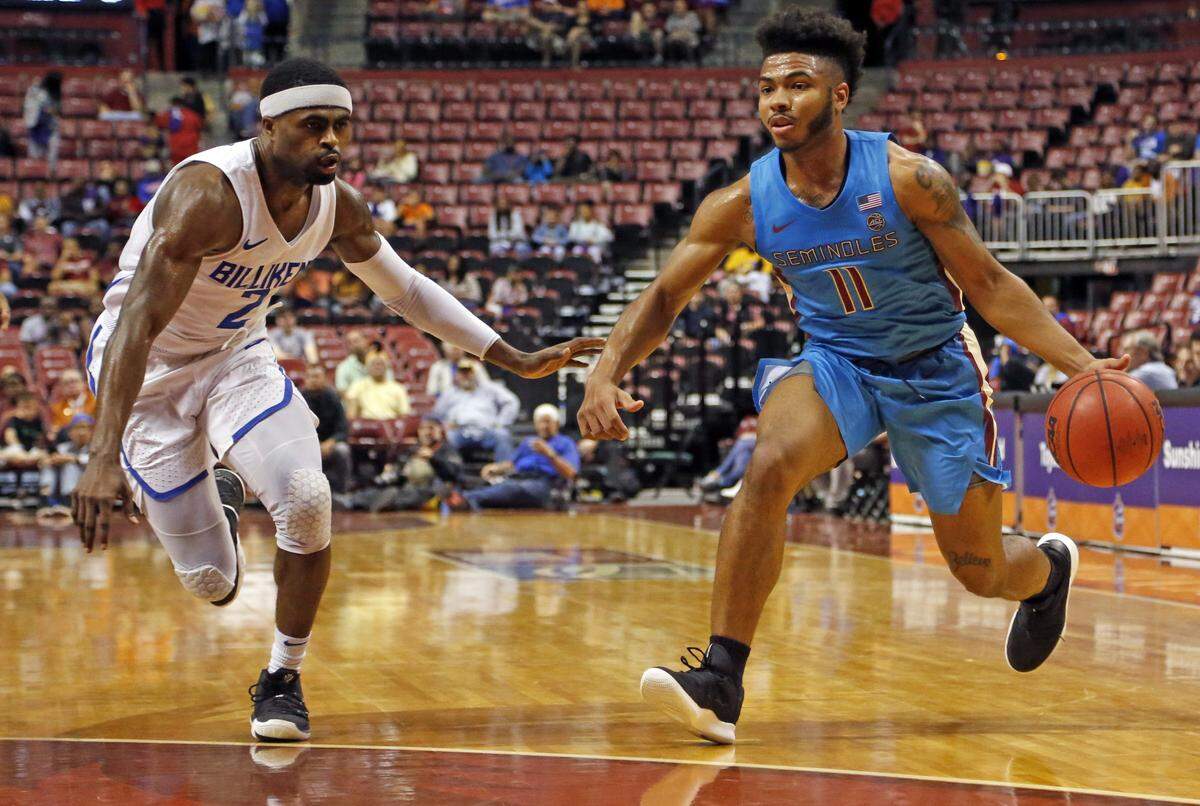 Florida State Seminoles guard David Nichols (11) drives the ball as Saint Louis Billikens guard Tramaine Isabell Jr. (2) defends in the fist half during game between Florida State University and Saint Louis University at the Orange Bowl Basketball Classic in the BB&T Center in Sunrise on Saturday, December 22, 2018.