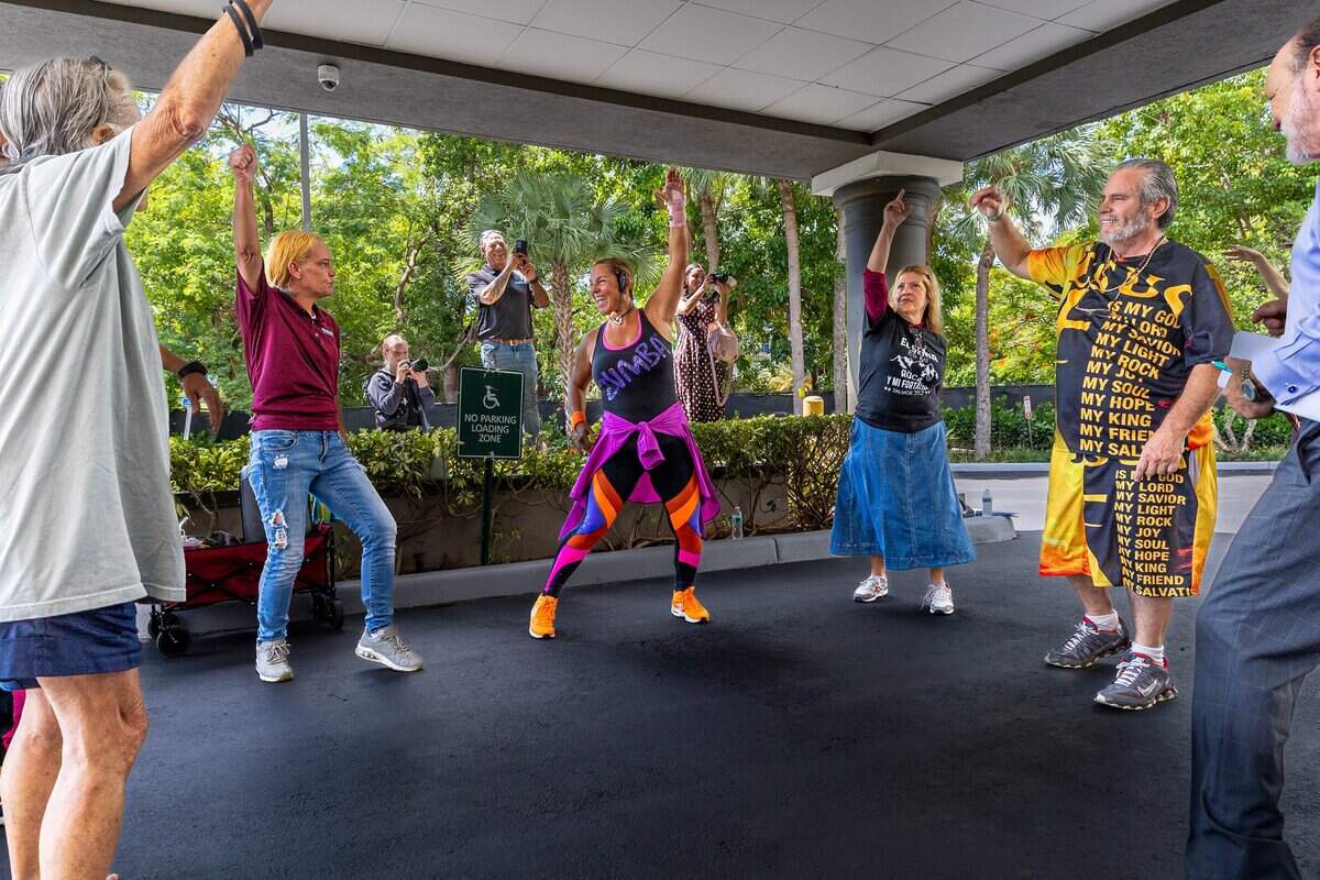 Paula Young, center, a line dance instructor, leads residents and staff in dancing at Miami-Dade Homeless Trust's Hideaway Bay in Cutler Bay, Fla., on Tuesday, June 30, 2026. Hideaway Bay is home to 93 residents and is South Florida's first hotel-to-housing conversion for seniors experiencing homelessness.