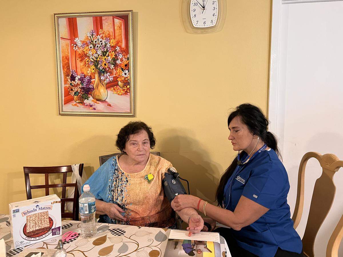 Yelena Munerman gets a visit from Tatyana Virsta, a nurse with Jewish Family Home Care, during Passover.