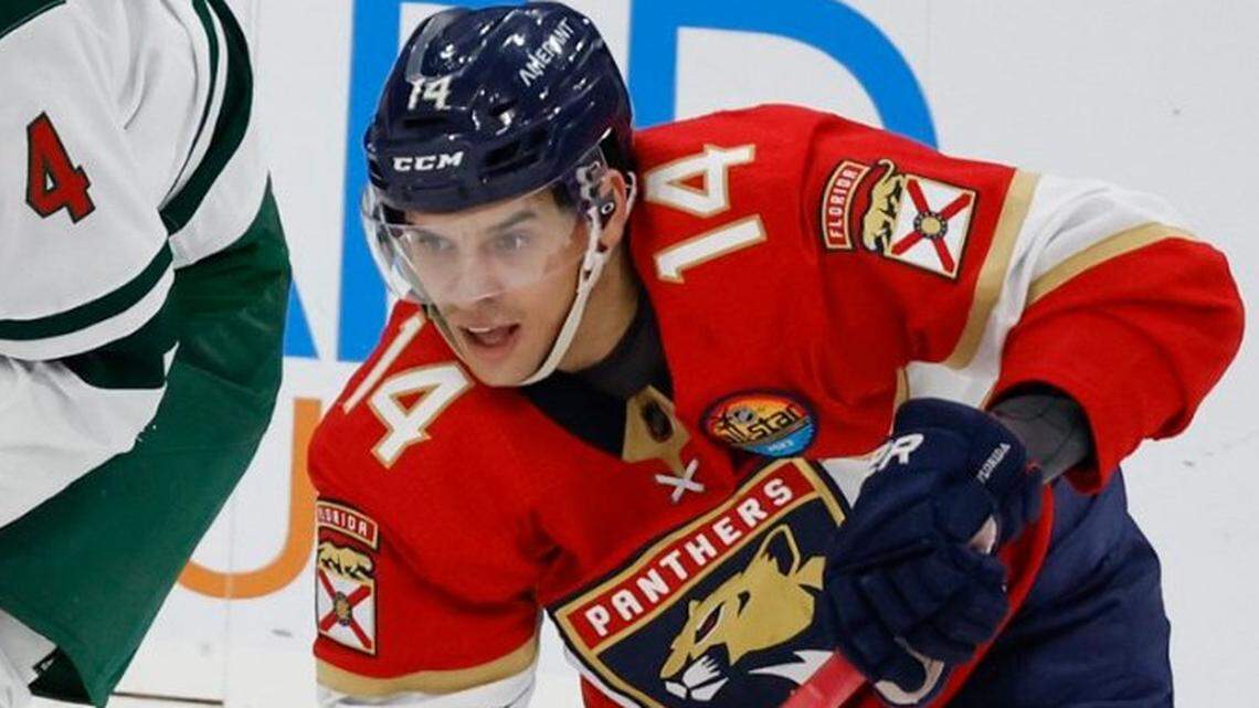 Florida Panthers left wing Grigori Denisenko (14) passes the puck as Minnesota Wild defenseman Jon Merrill (4) defends in the second period at FLA Live Arena in Sunrise, FL on Saturday, January 21, 2023.