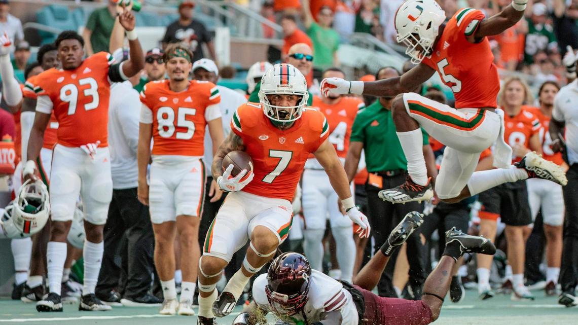 Miami Hurricanes wide receiver Xavier Restrepo (7) breaks a tackle on a long pass reception in the second quarter against Bethune Cookman Wildcats at Hard Rock Stadium in Miami Gardens on Saturday, September 3, 2022.