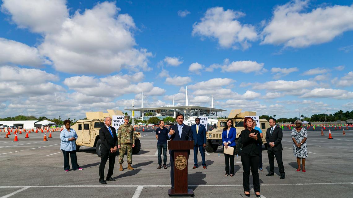 Joined by mayors from Miami-Dade, Broward, Palm Beach and Monroe counties, Florida Gov. Ron DeSantis, center, said during a press conference Monday that he’ll ease restrictions that will allow retired first responders and healthcare workers to return to work.