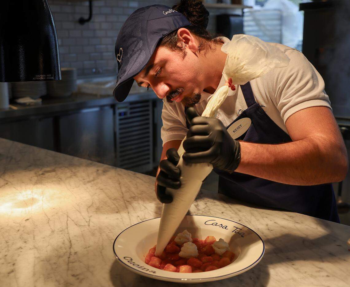 A line cook carefully completes a lunch order at Casa Tua Cucina in Miami's Wynwood Art District on Thursday, April 16, 2026. Casa Tua Cucina in Wynwood, a spacious, upscale Italian food hall and restaurant features an open layout with high ceilings, communal tables, and multiple dedicated dining areas-making it suitable for both intimate dinners and larger group gatherings.