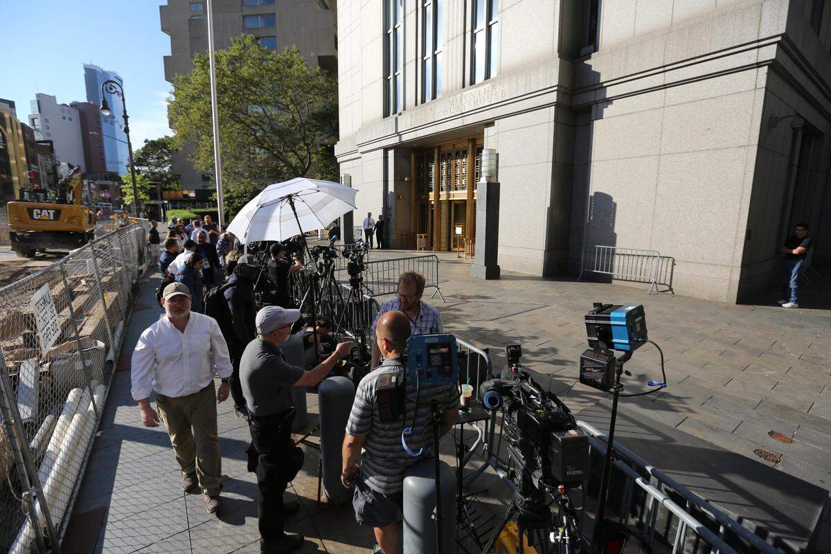 Media lines the sidewalk outside of the Daniel Patrick Moynihan federal courthouse in Manhattan awaiting a bond hearing for Jeffrey Epstein.