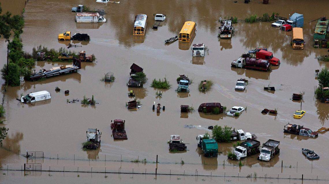 In this aerial photo over Amite, La., flooded homes are seen from heavy rains inundating the region, Saturday, Aug. 13, 2016.