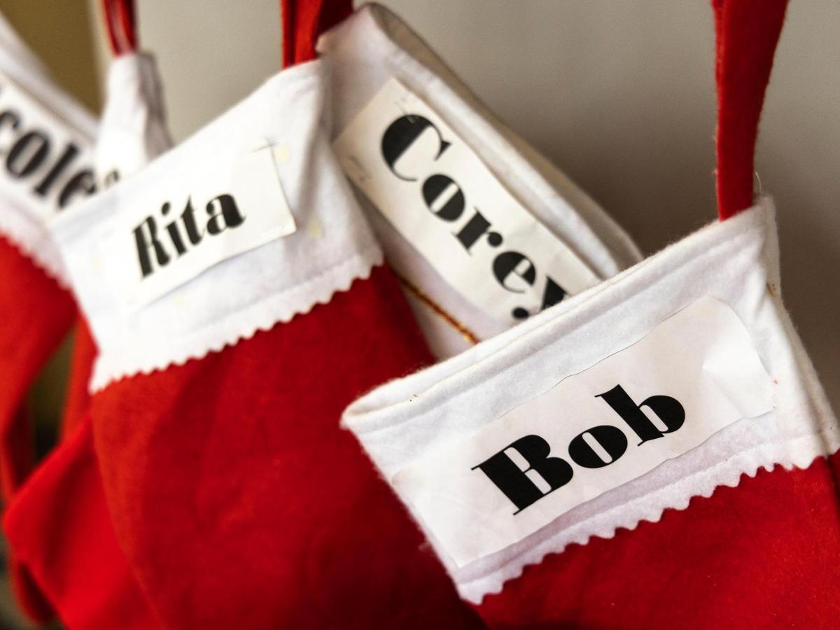Christmas stockings with the names of Bob Maguire, partner Rita Tennyson and her family are displayed on the counter of the Coral Gables dinner at its original location on Monday, Dec. 20, 2021.