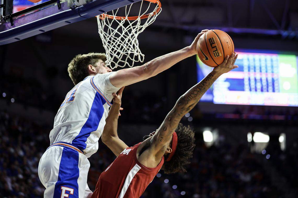GAINESVILLE, FLORIDA - FEBRUARY 1: Alex Condon #21 of the Florida Gators blocks a shot by Amari Allen #5 of the Alabama Crimson Tide during the second half of a game at the Stephen C. O'Connell Center on February 1, 2026 in Gainesville, Florida. (Photo by James Gilbert/Getty Images)