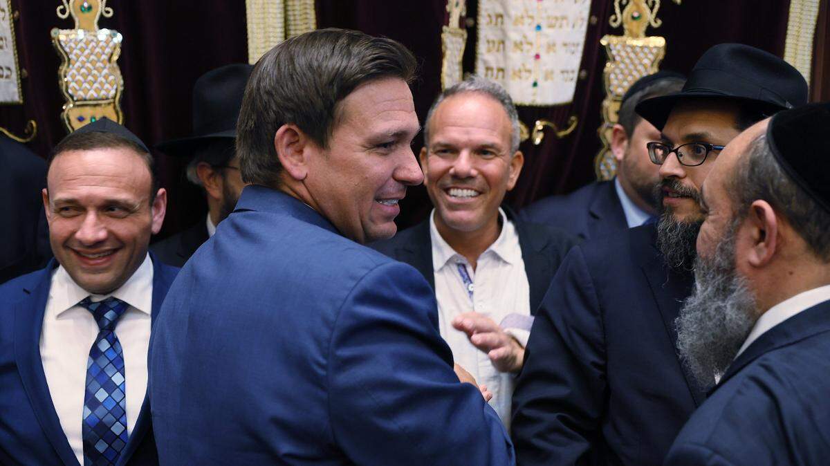 Florida Gov. Ron DeSantis greets people after signing two bills at the Shul of Bal Harbour on June 14, 2021, in Surfside, Florida. The bills ensure that volunteer ambulance services, including Hatzalah, can operate, and that Florida schools hold a daily moment of silence.