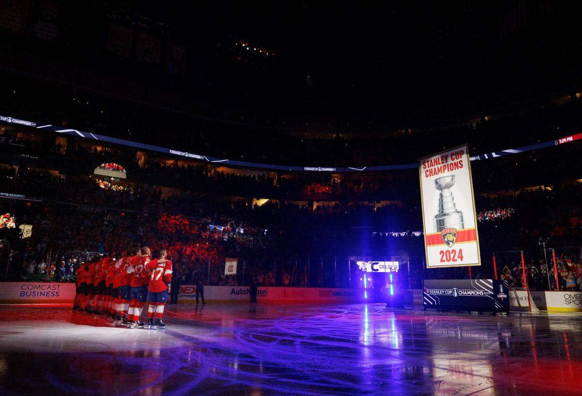Florida Panthers watch their Championship banner being raised before the home opener of the Florida Panthers against the Boston Bruins on Tuesday, Oct. 8, 2024, at Amerant Bank Arena in Sunrise, Fla.