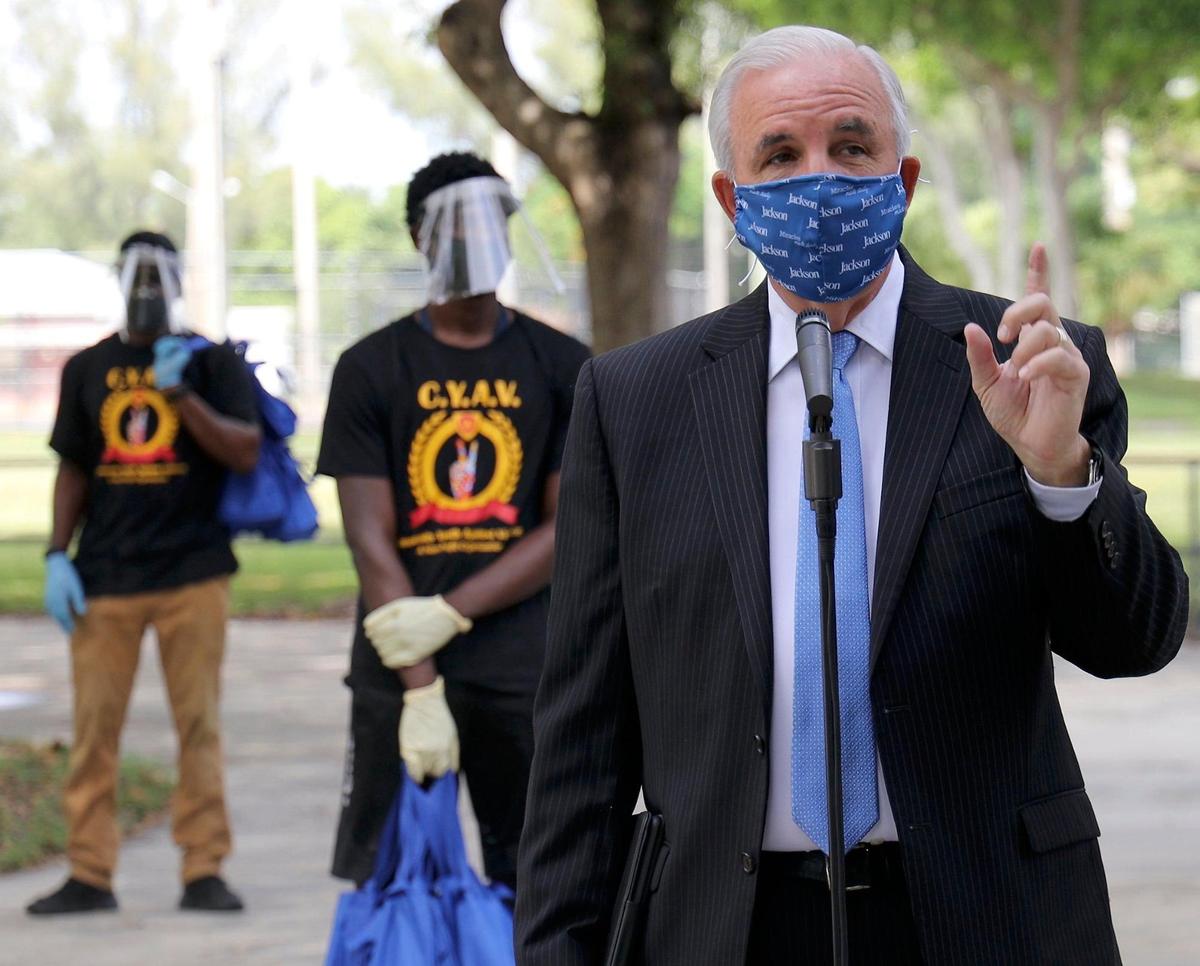 Miami-Dade County Mayor Carlos Gimenez speaks at a press conference on July 2, 2020, announcing that a team of mask distributors supported by the county and members of the Community Youth Against Violence will hand out masks to assure that county residents wear them outside their homes. On July 6, 2020, he announced restaurants would be closing dining rooms again.