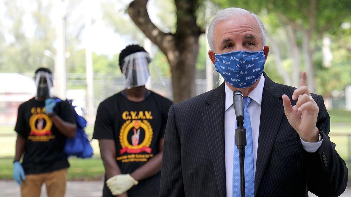 Miami-Dade County Mayor Carlos Gimenez speaks at a press conference on July 2, 2020, announcing that a team of mask distributors supported by the county and members of the Community Youth Against Violence will hand out masks to assure that county residents wear them outside their homes.